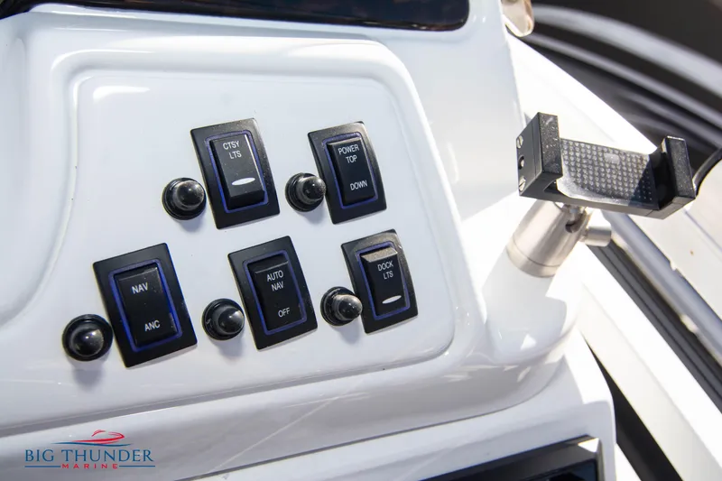 Slide: The Image of Control panel of a 2022 JC NEPTOON 27 TT SPORT boat with various switches. - 30