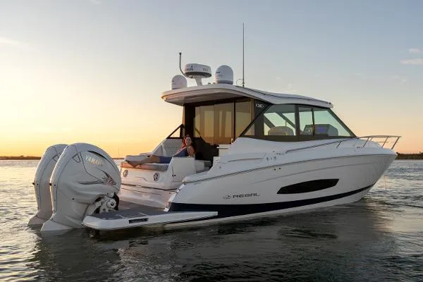 The Image of 2023 Regal 36 XO luxury motor yacht on water at sunset. - 0