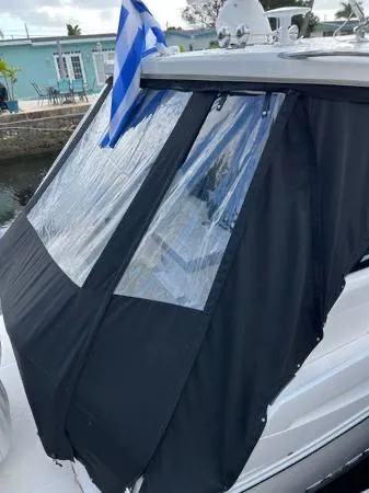 Slide: The Image of 2023 Regal 36 XO yacht with black window covers docked. - 10