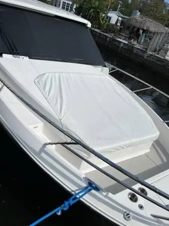 Slide: The Image of 2023 Regal 36 XO boat docked with covered seating area. - 11