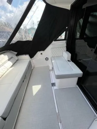 Slide: The Image of 2023 Regal 36 XO boat interior with seating and windows. - 12