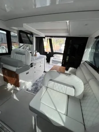 Slide: The Image of Interior of 2023 Regal 36 XO yacht with luxurious seating and modern amenities. - 16