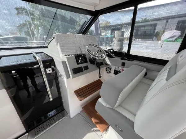 Slide: The Image of 2023 Regal 36 XO boat interior with modern helm and seating. - 7