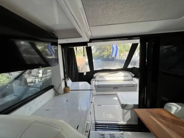 Slide: The Image of Interior of 2023 Regal 36 XO yacht with modern seating and large windows. - 8