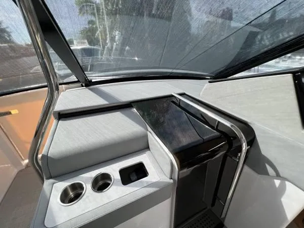 Slide: The Image of 2023 Regal 36 XO boat interior helm with modern controls and cup holders. - 9
