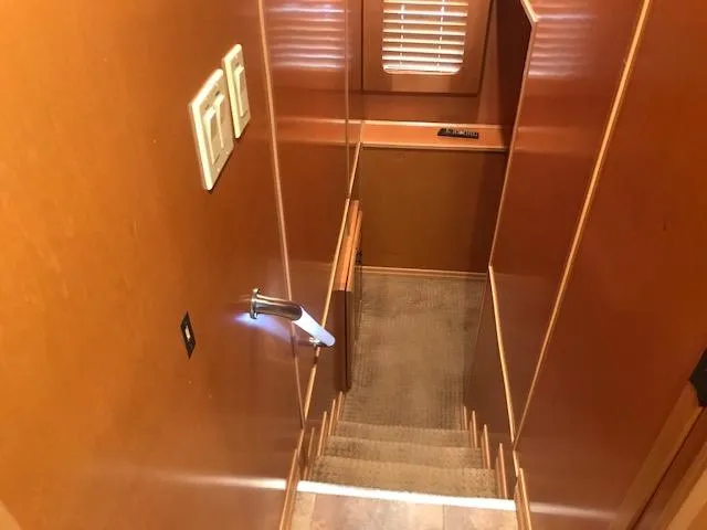 Slide: The Image of Staircase inside a 2007 Thoroughbred houseboat with wooden walls and carpeted steps. - 20