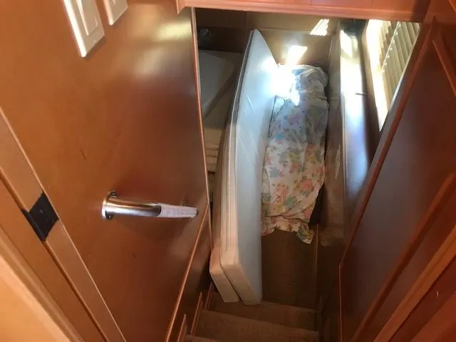 Slide: The Image of Interior of 2007 Thoroughbred houseboat with narrow stairs and a small bed. - 23