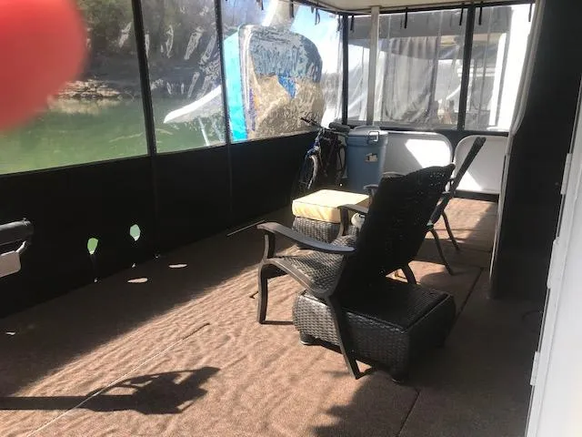 Slide: The Image of 2007 Thoroughbred Houseboat interior with seating area and lake view. - 3