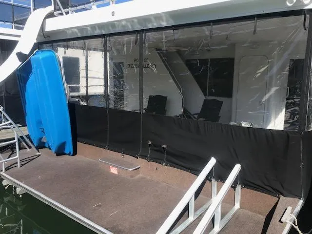 Slide: The Image of 2007 Thoroughbred houseboat with covered deck and blue kayak. - 30