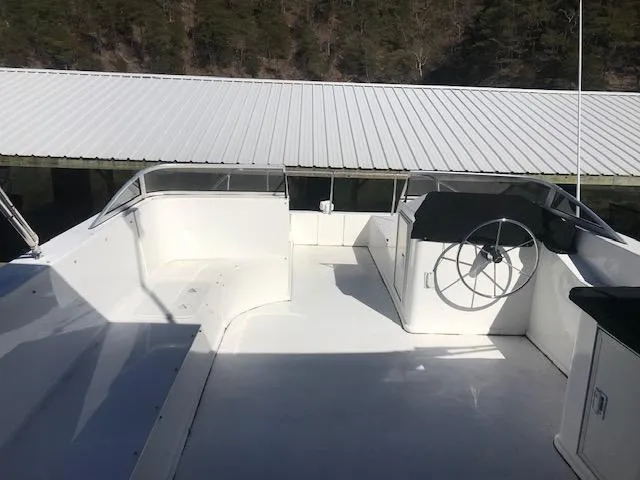 Slide: The Image of 2007 Thoroughbred Houseboat upper deck with steering wheel and seating area. - 34