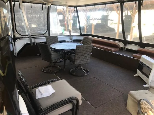Slide: The Image of Spacious interior of a 2007 Thoroughbred houseboat with seating and dining area. - 4