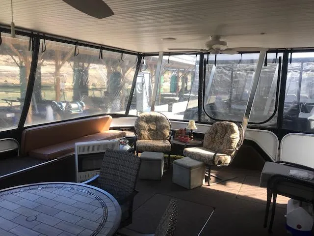 Slide: The Image of Interior of a 2007 Thoroughbred houseboat with cozy seating and large windows. - 5