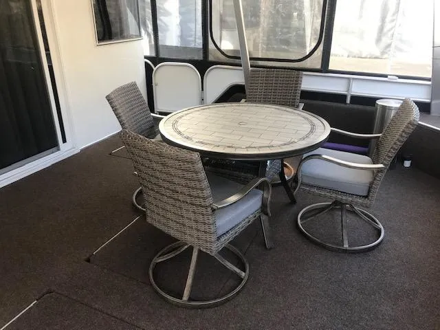 Slide: The Image of Outdoor seating area on a 2007 Thoroughbred houseboat with wicker chairs and a round table. - 6
