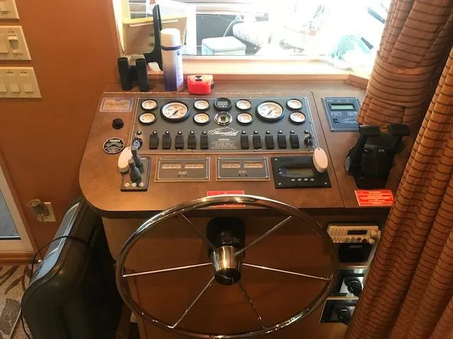 Slide: The Image of Control panel of a 2007 Thoroughbred Houseboat with steering wheel and gauges. - 7