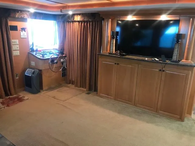 Slide: The Image of 2007 Thoroughbred houseboat interior with entertainment center and control panel. - 8