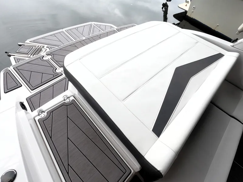 Slide: The Image of 2023 Monterey M-22 boat with sleek deck and cushioned seating. - 14