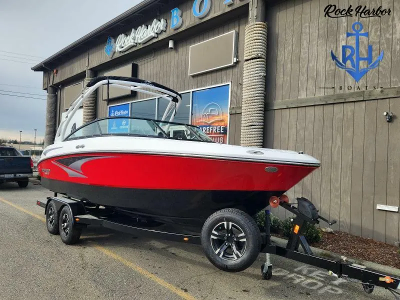 Slide: The Image of 2023 Monterey M-22 boat in red and black on a trailer at Rock Harbor Boats. - 2