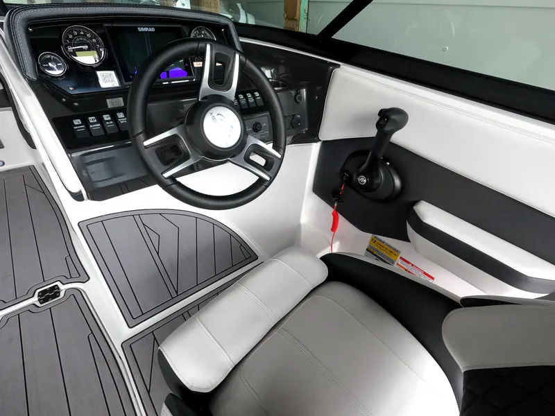 Slide: The Image of 2023 Monterey M-22 boat cockpit with steering wheel and control panel. - 21