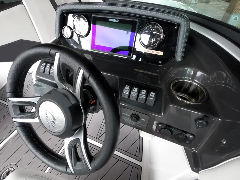Slide: The Image of 2023 Monterey M-22 boat dashboard with steering wheel and control panel. - 22