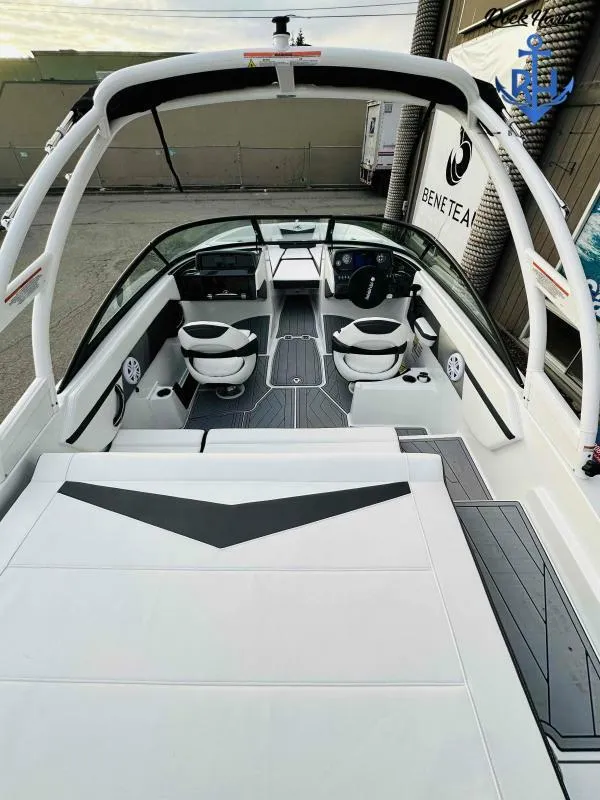 Slide: The Image of 2023 Monterey M-22 boat interior with white and black seating, modern dashboard, and spacious layout. - 24