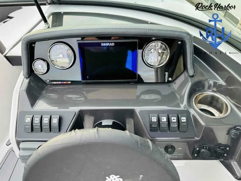 Slide: The Image of Dashboard of 2023 Monterey M-22 boat with Simrad display and control switches. - 27