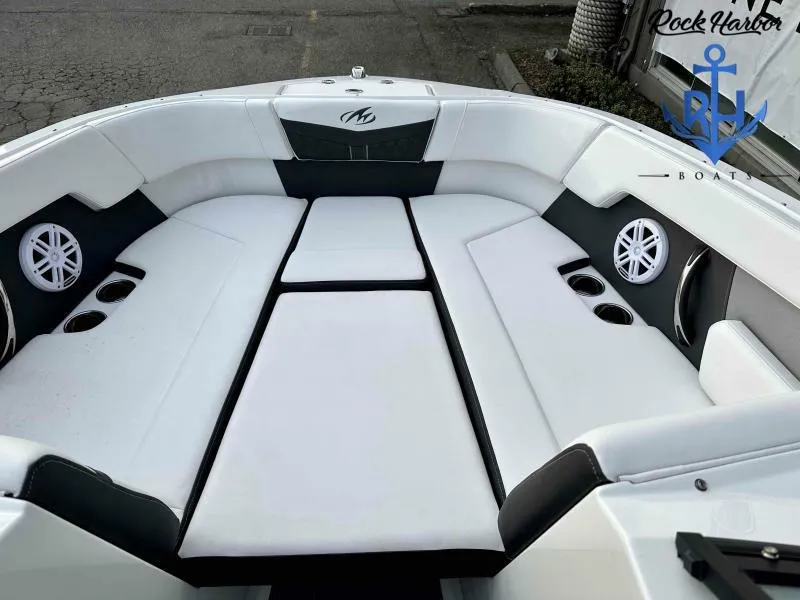 Slide: The Image of 2023 Monterey M-22 boat interior with white seating and cup holders. - 29
