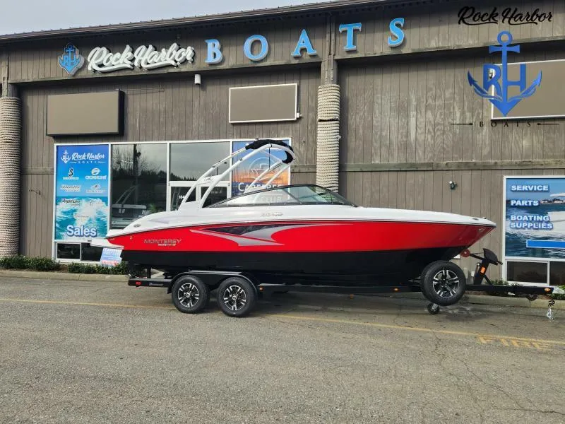 Slide: The Image of 2023 Monterey M-22 boat in red and black at Rock Harbor Boats dealership. - 3