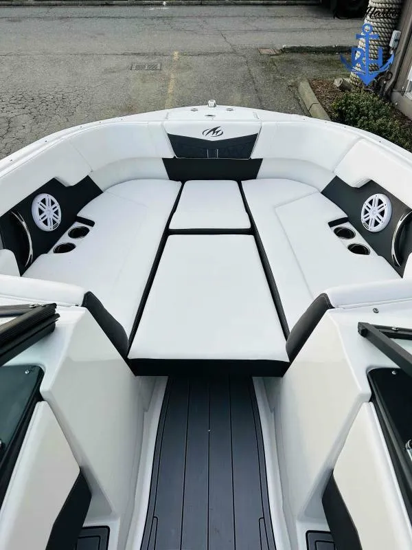 Slide: The Image of 2023 Monterey M-22 boat interior with white seating and cup holders. - 30