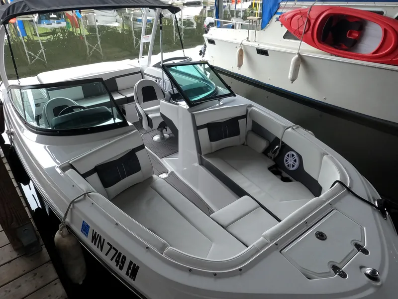 Slide: The Image of 2023 Monterey M-22 boat docked, featuring spacious seating and modern design. - 4