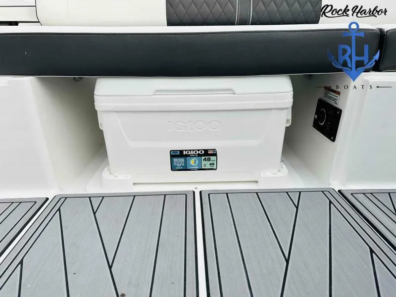 Slide: The Image of 2023 Monterey M-22 boat with Igloo cooler and Rock Harbor Boats logo. - 41