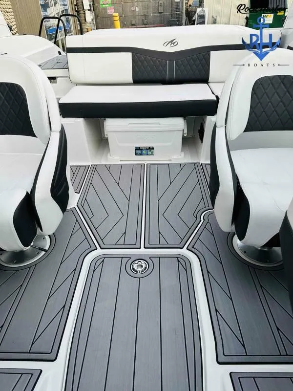 Slide: The Image of 2023 Monterey M-22 boat interior with black and white seating and grey flooring. - 42