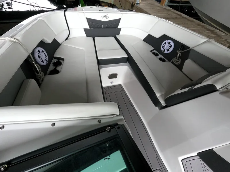 Slide: The Image of 2023 Monterey M-22 boat interior with white and gray seating, speakers, and deck. - 45