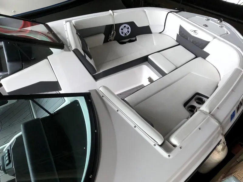 Slide: The Image of 2023 Monterey M-22 boat interior with white and gray seating. - 6