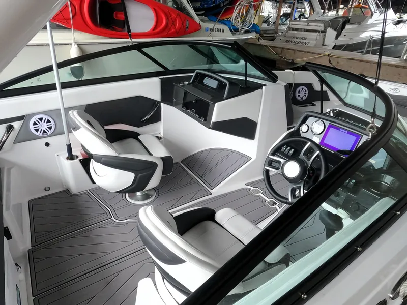 Slide: The Image of 2023 Monterey M-22 boat interior with modern dashboard and seating. - 9