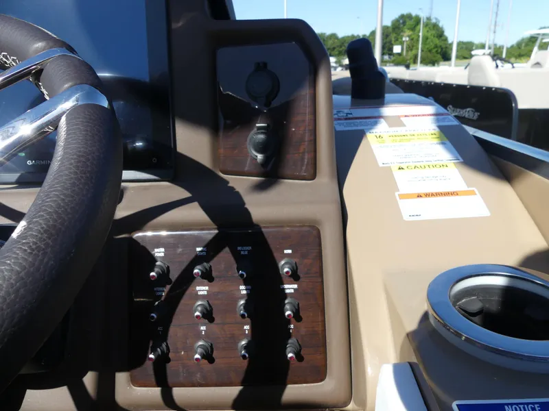 Slide: The Image of Control panel of 2023 Silver Wave 2610 CLS SW7 boat with steering wheel and switches. - 10