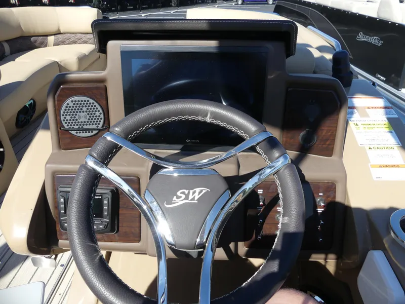 Slide: The Image of 2023 Silver Wave 2610 CLS SW7 boat dashboard with steering wheel and control panel. - 11