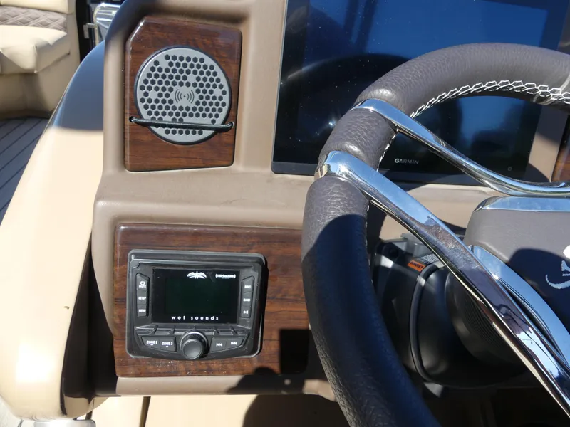Slide: The Image of 2023 Silver Wave 2610 CLS SW7 boat dashboard with steering wheel and audio controls. - 12