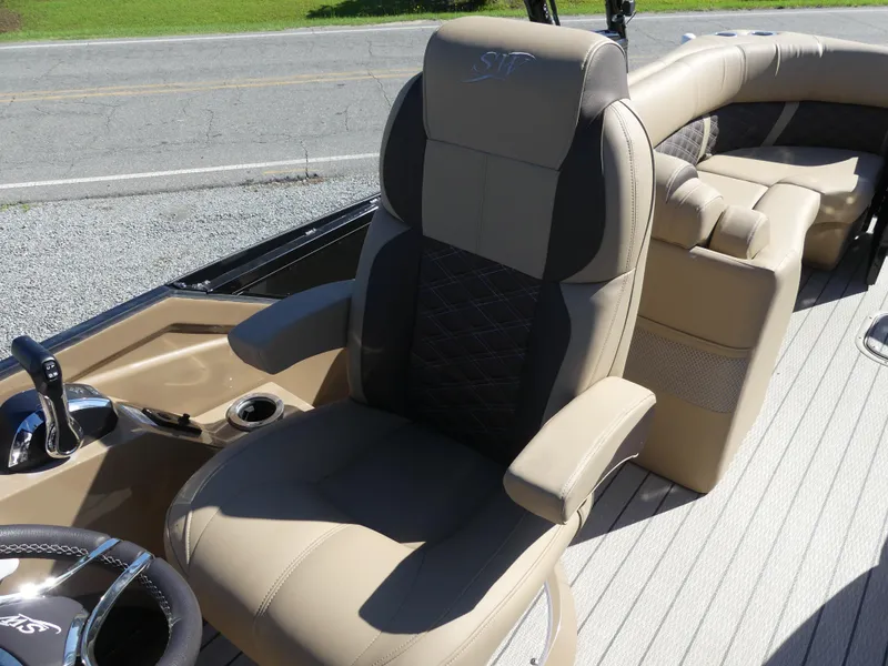 Slide: The Image of 2023 Silver Wave 2610 CLS SW7 boat interior with luxurious captain's chair and steering console. - 14