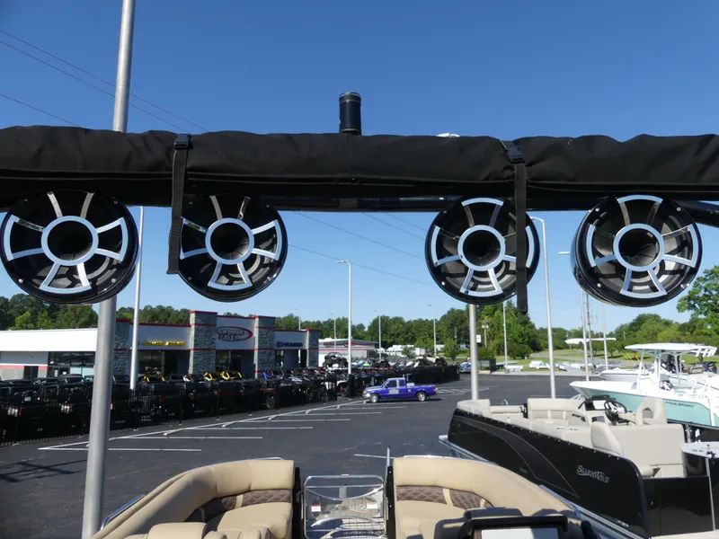 Slide: The Image of 2023 Silver Wave 2610 CLS SW7 boat with mounted speakers in a dealership lot. - 15