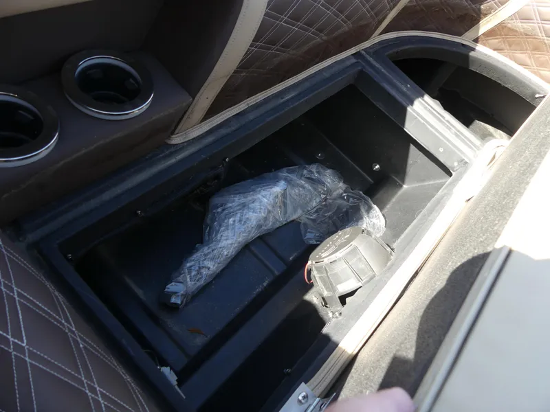 Slide: The Image of Storage compartment in 2023 Silver Wave 2610 CLS SW7 boat with cup holders and quilted seats. - 18