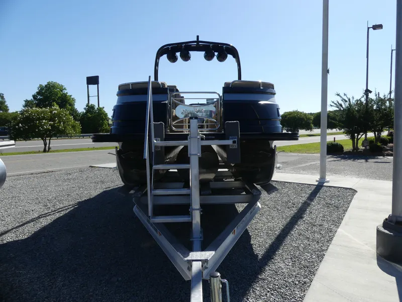Slide: The Image of 2023 Silver Wave 2610 CLS SW7 pontoon boat on a trailer, front view. - 3