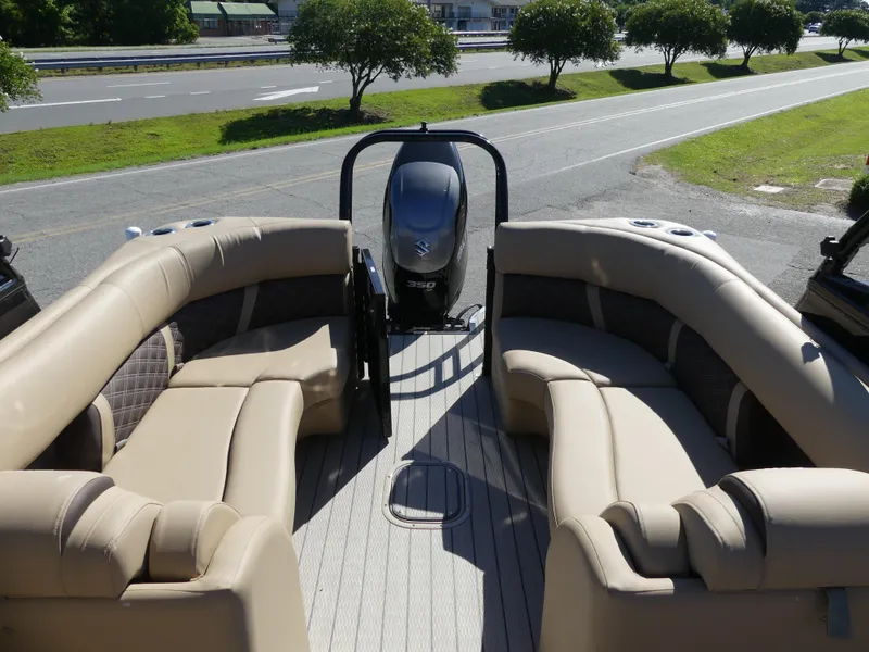 Slide: The Image of 2023 Silver Wave 2610 CLS SW7 pontoon boat with beige seating and outboard motor. - 6