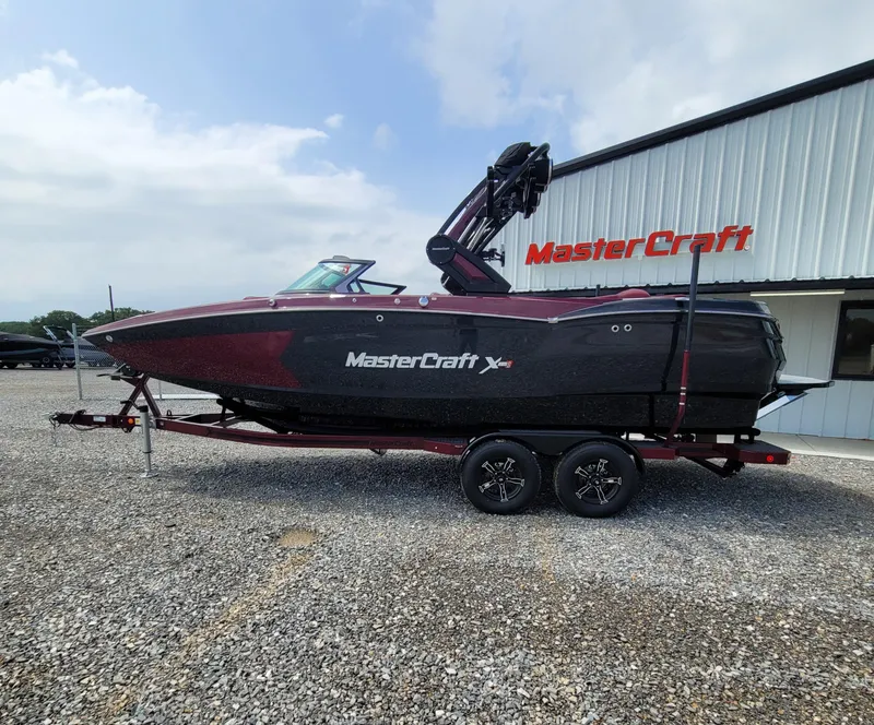 Slide: The Image of 2023 MasterCraft XStar S boat parked outside dealership. - 13