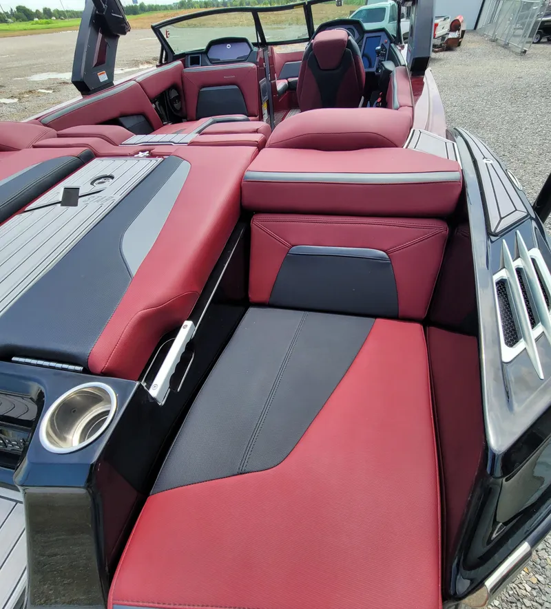 Slide: The Image of 2023 MasterCraft XStar S boat interior with red and black seating. - 22