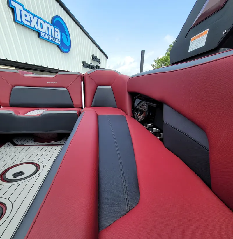 Slide: The Image of 2023 MasterCraft XStar S interior with red and black seating at Texoma Boathouse. - 23