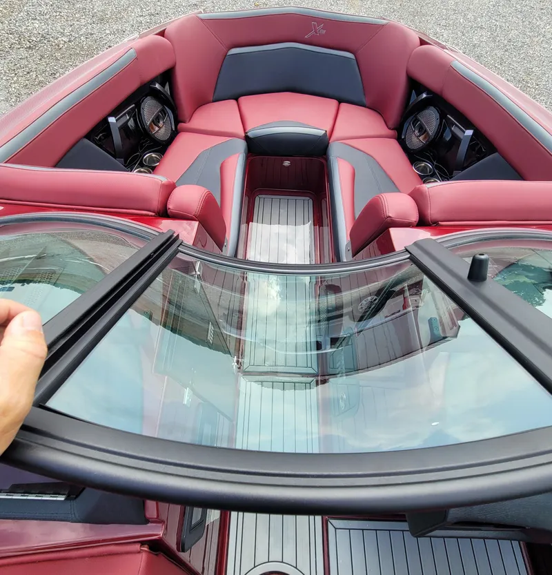 Slide: The Image of 2023 MasterCraft XStar S boat interior with red seating and sleek design. - 24