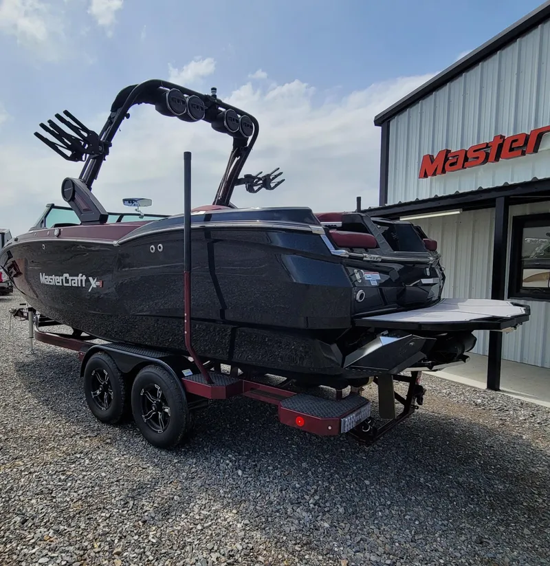 Slide: The Image of 2023 MasterCraft XStar S boat on trailer outside dealership. - 3