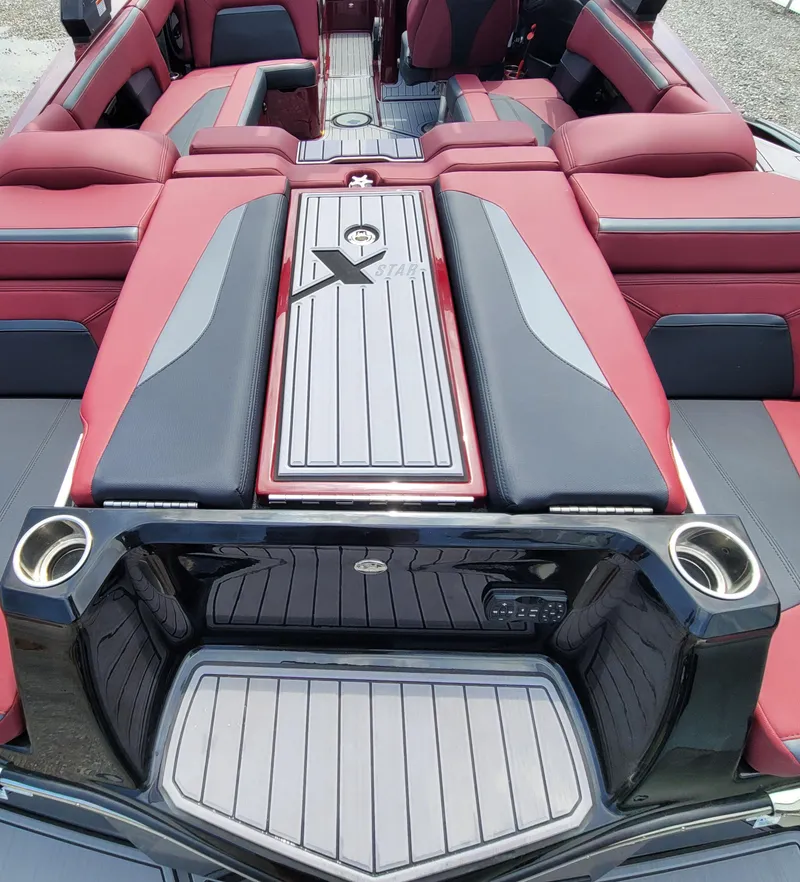 Slide: The Image of 2023 MasterCraft XStar S boat interior with red and black seating and sleek design. - 5
