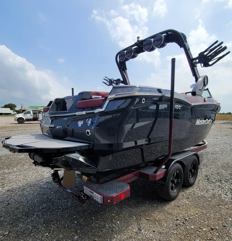 Slide: The Image of 2023 MasterCraft XStar S boat on trailer, rear view, outdoors. - 6