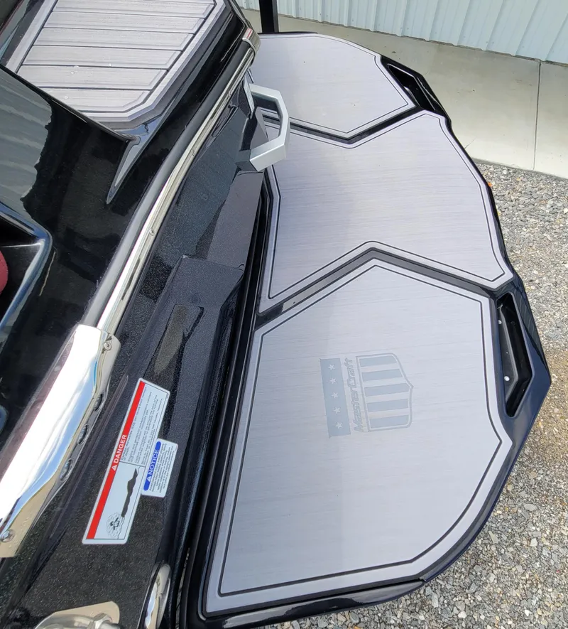 Slide: The Image of 2023 MasterCraft XStar S swim platform with sleek design and textured surface. - 9